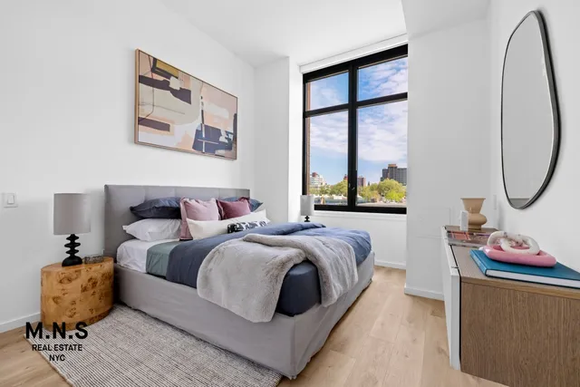 a bedroom with bed and a window