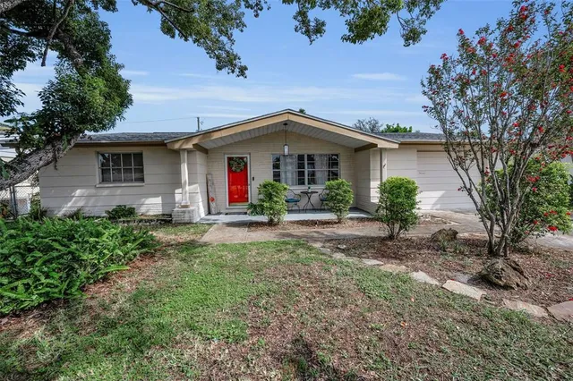 a front view of a house with yard and green space