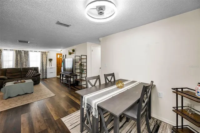 a view of a dining room with furniture and a chandelier