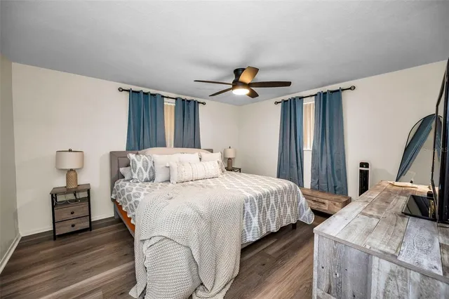 a bedroom with double bed and a flat tv screen on dresser