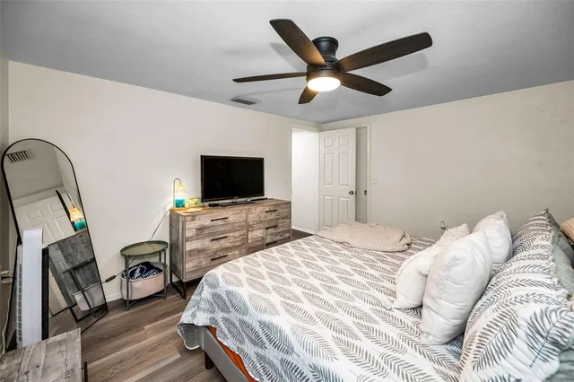 a bedroom with a bed and a flat screen tv