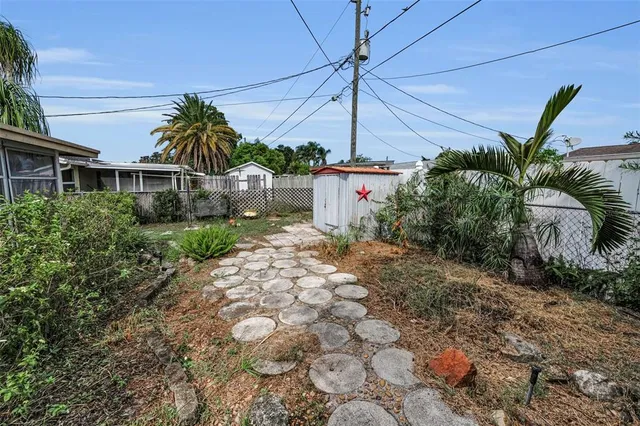 a view of a house with a yard and potted plants
