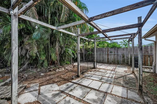 a backyard of a house with table and chairs