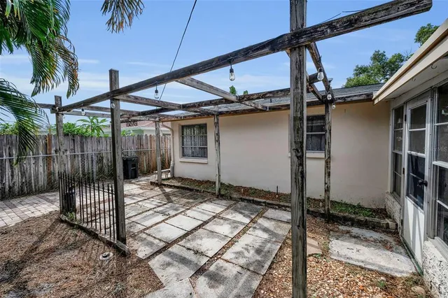 a view of a house with a door and wooden walls