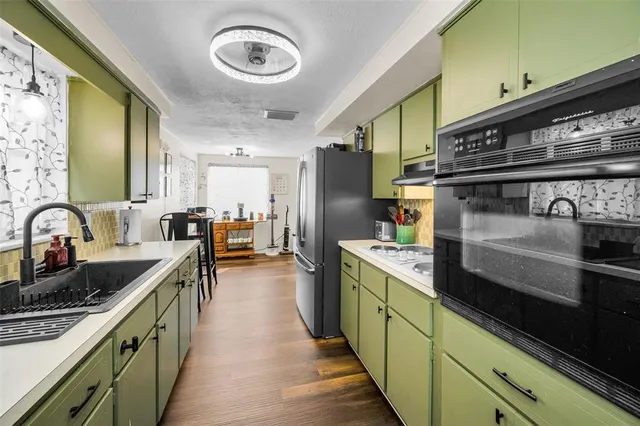 a kitchen with lots of counter top space and stainless steel appliances