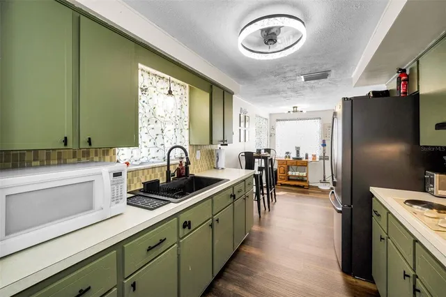 a kitchen with lots of counter space and stainless steel appliances