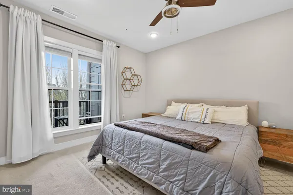 a bedroom with a bed and a window