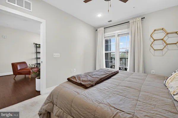 a bedroom with a large bed and a chair