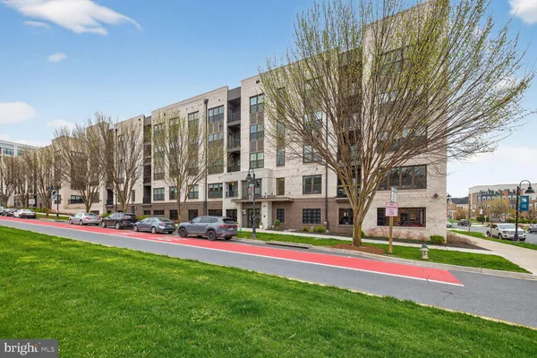 a multi story building with trees in front of it