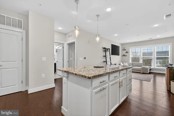 a large white kitchen with a large window