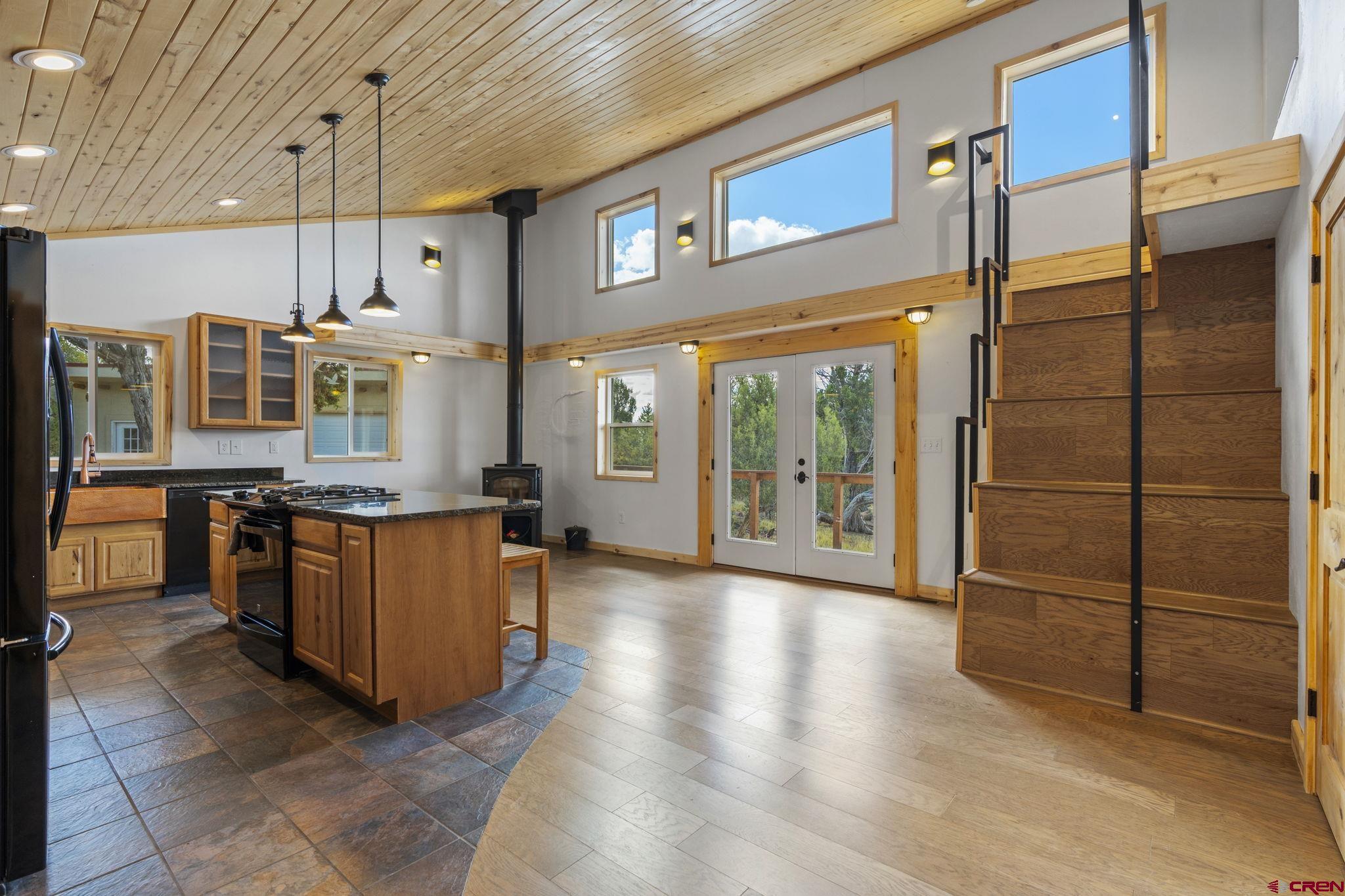 35510 Rd J.8 Mancos, CO 81328 - Photo 2 of 41 a kitchen with stainless steel appliances granite countertop a refrigerator a oven and a sink with wooden cabinets