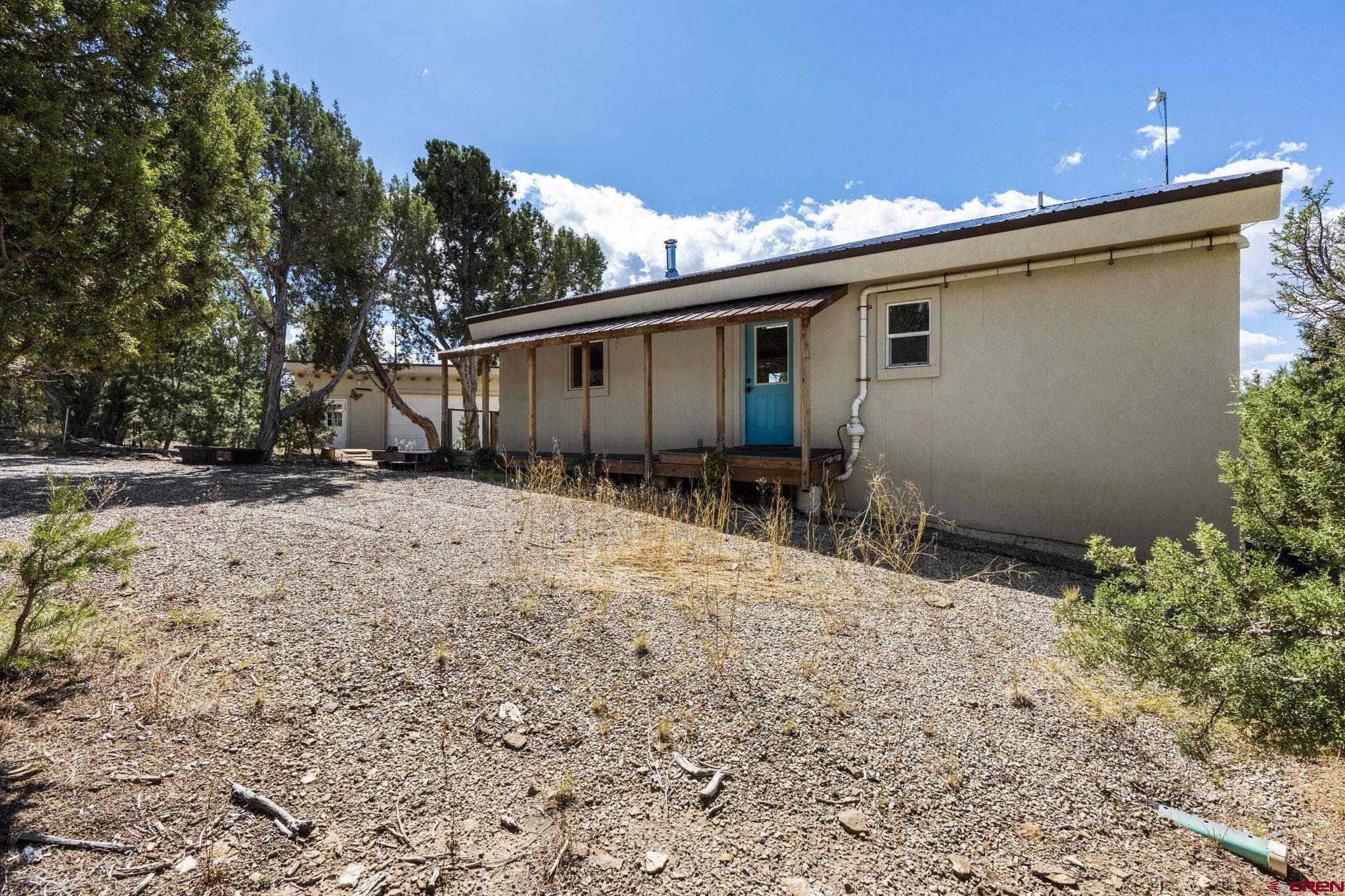 35510 Rd J.8 Mancos, CO 81328 - Photo 24 of 41 a backyard of a house with table and chairs