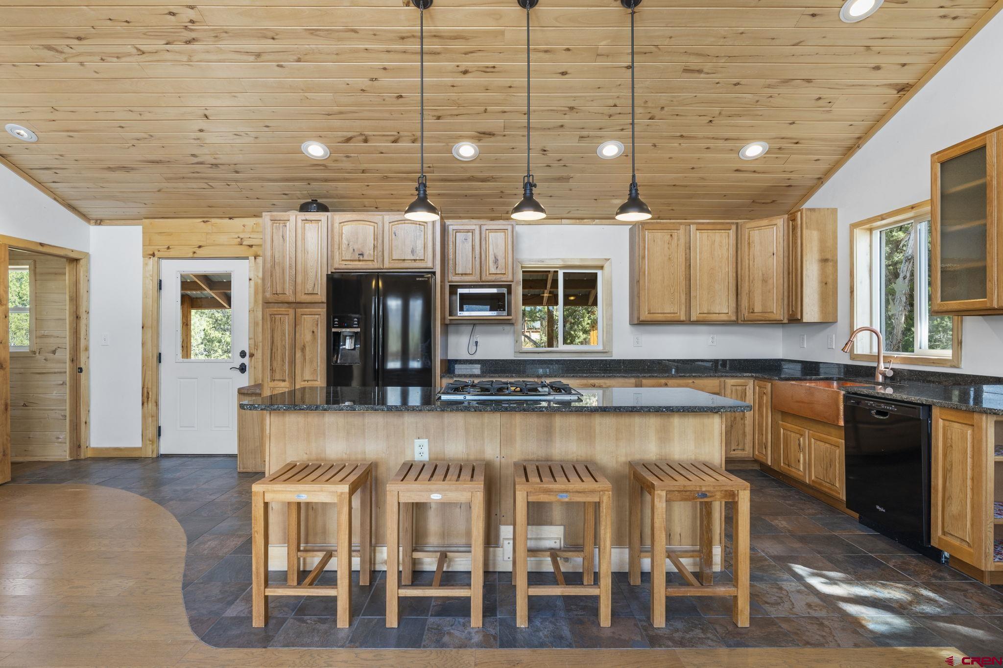 35510 Rd J.8 Mancos, CO 81328 - Photo 5 of 41 a kitchen with a dining table chairs cabinets and wooden floor
