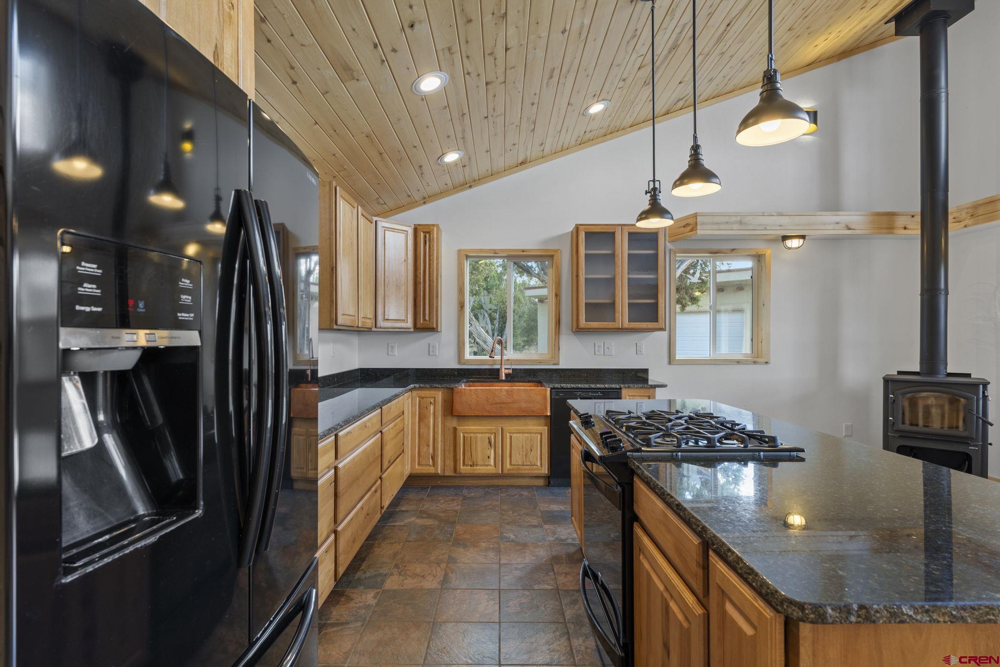 35510 Rd J.8 Mancos, CO 81328 - Photo 7 of 41 a kitchen with stainless steel appliances granite countertop a sink stove and refrigerator