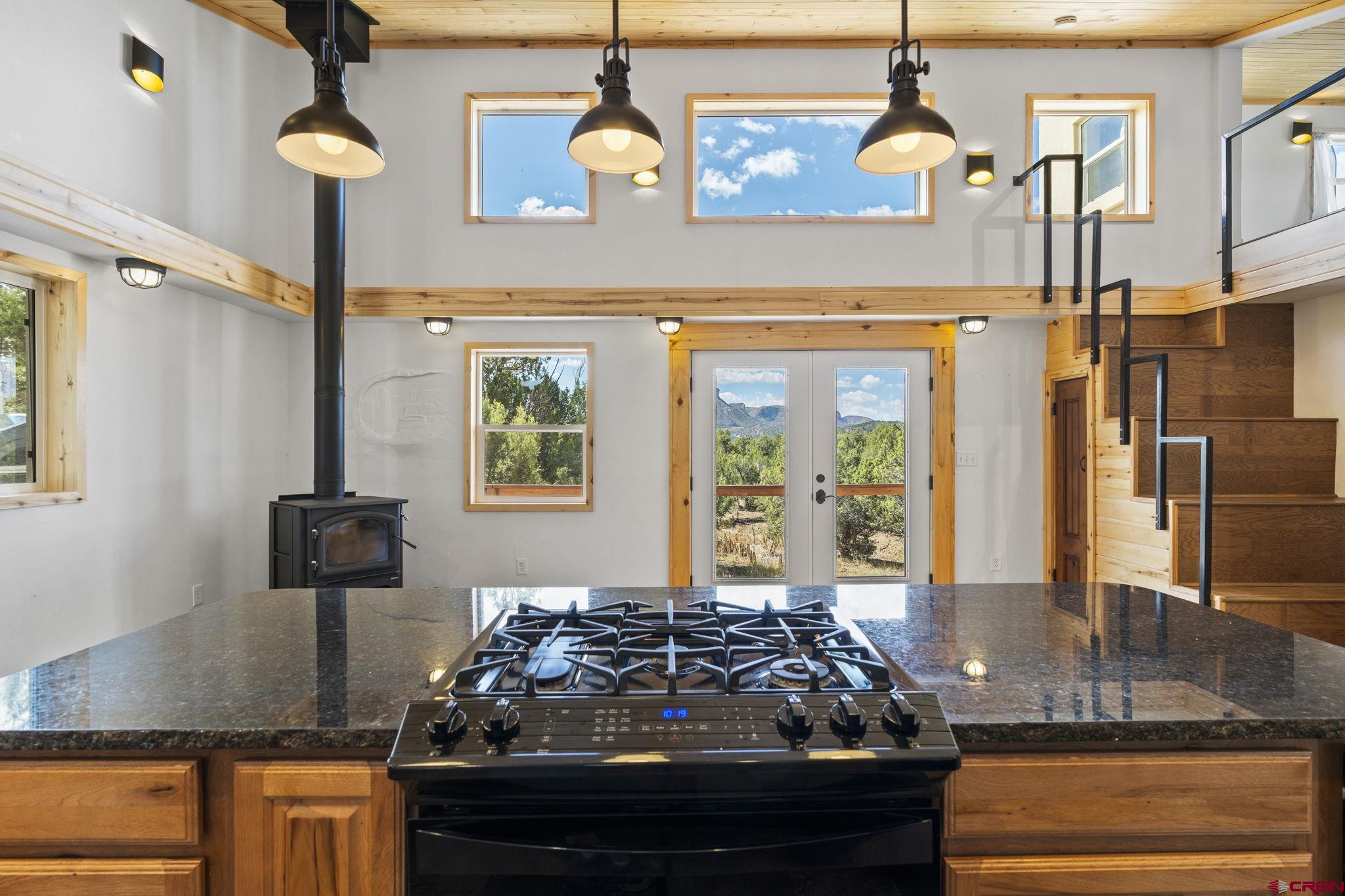 35510 Rd J.8 Mancos, CO 81328 - Photo 9 of 41 a kitchen with kitchen island granite countertop a stove and a sink