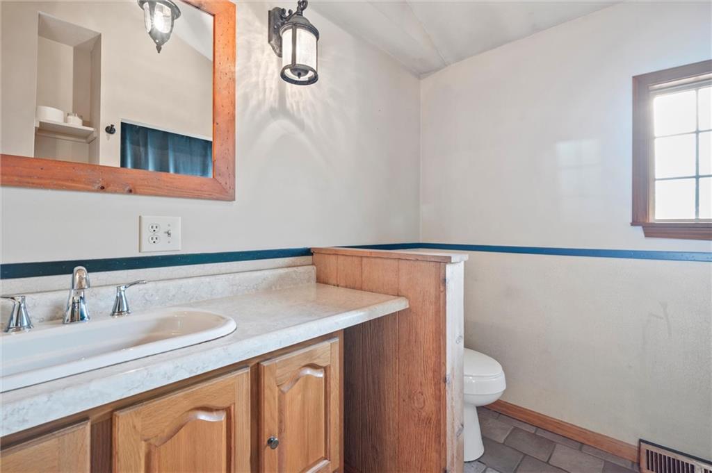 3766 North Balsiger Road Vandergrift, PA 15690 - Photo 17 of 34 a bathroom with a sink a toilet and a mirror