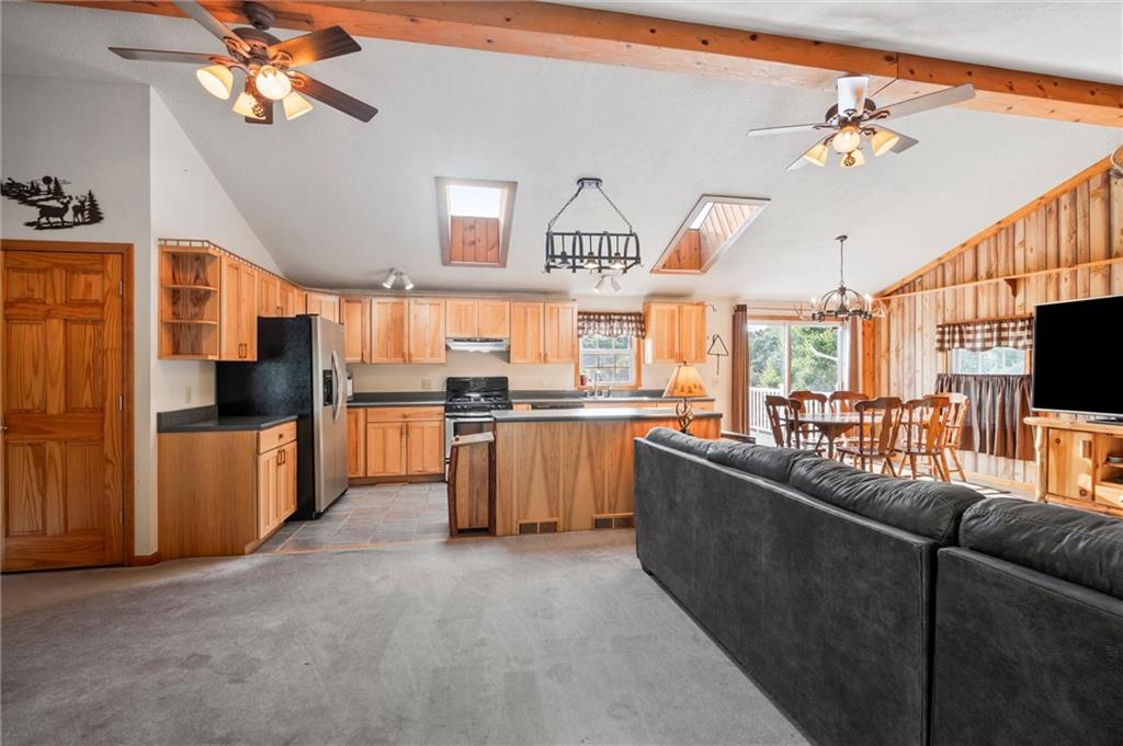 3766 North Balsiger Road Vandergrift, PA 15690 - Photo 4 of 34 a kitchen with stainless steel appliances kitchen island granite countertop a refrigerator a sink dishwasher a stove and a dining table with wooden floor