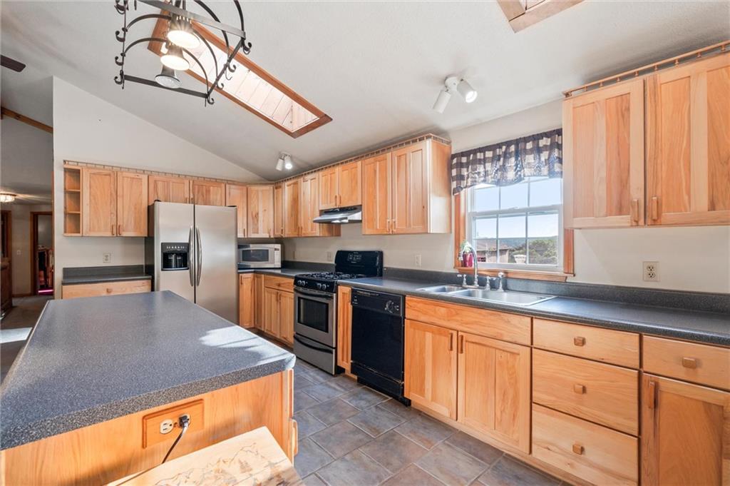 3766 North Balsiger Road Vandergrift, PA 15690 - Photo 8 of 34 a kitchen with stainless steel appliances granite countertop a sink a stove cabinets counter space and a window