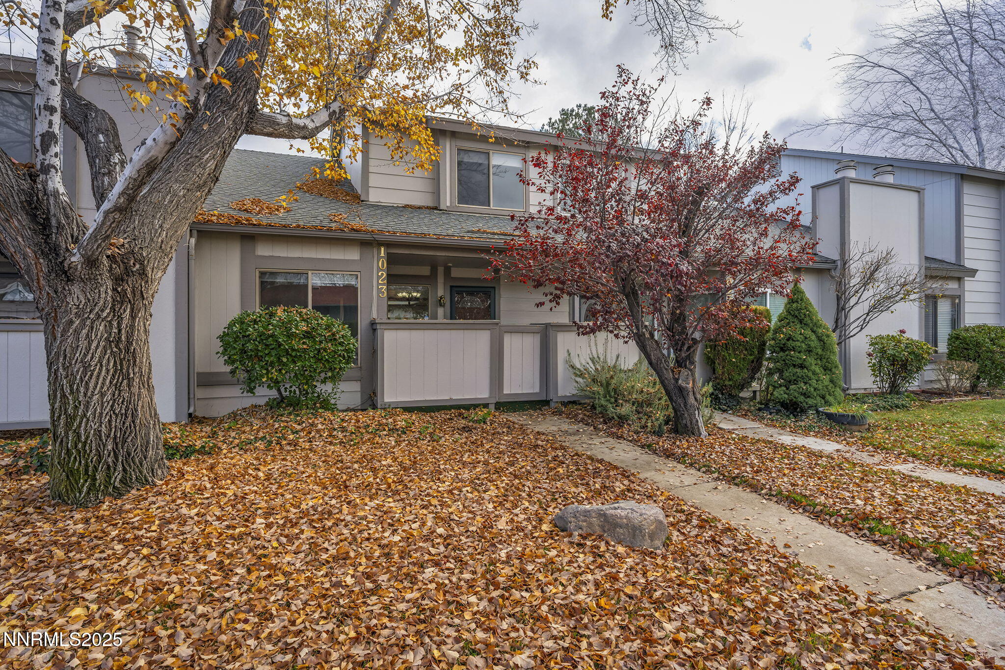 1023 Tyler Way Sparks, NV 89431 - Photo 1 of 21 a front view of a house with a garden