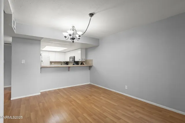a view of a kitchen with a sink and a window