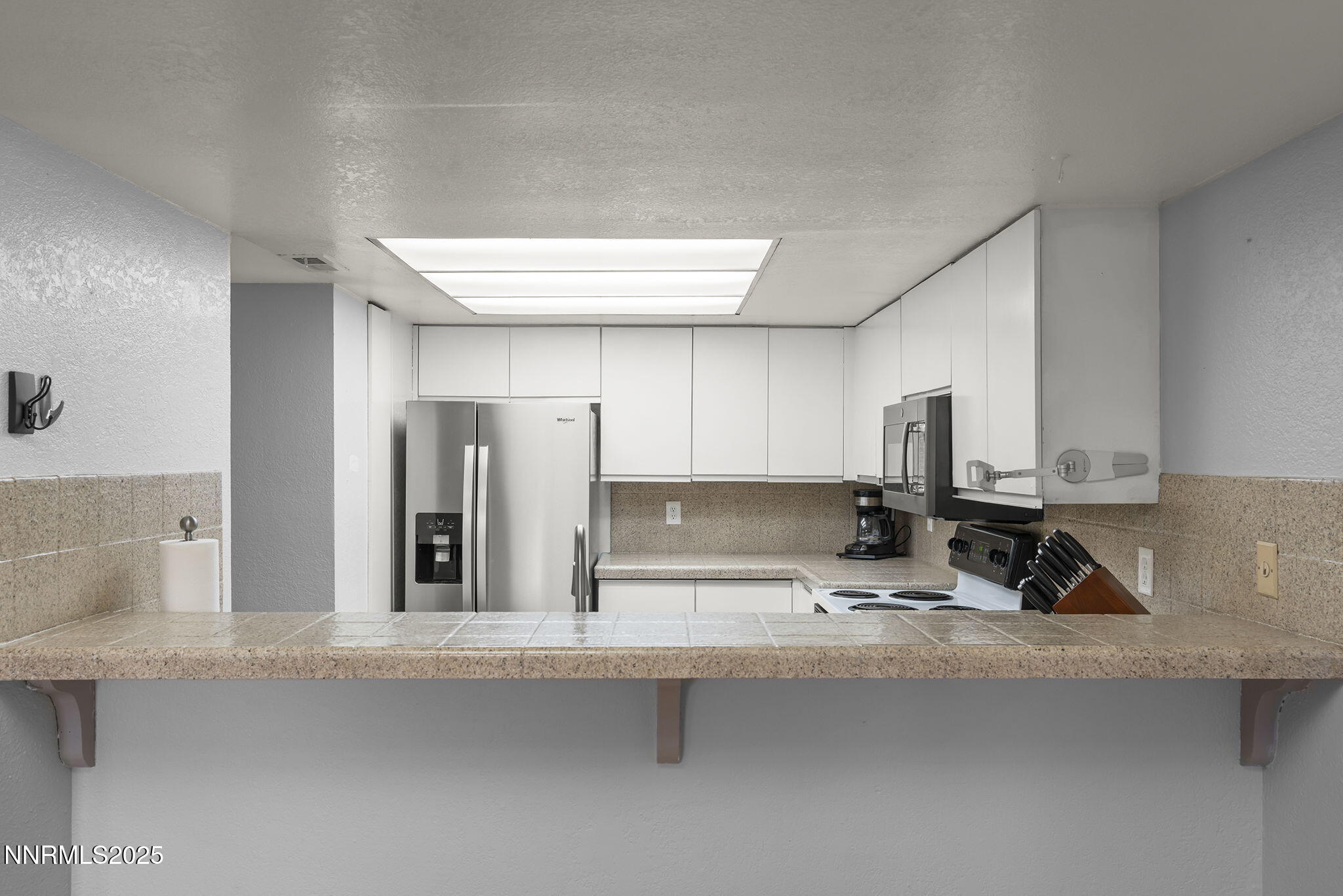 1023 Tyler Way Sparks, NV 89431 - Photo 12 of 21 a kitchen with stainless steel appliances a sink and cabinets