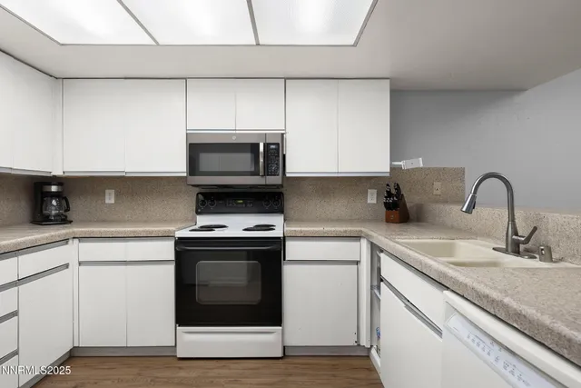 a kitchen with sink a microwave and stove