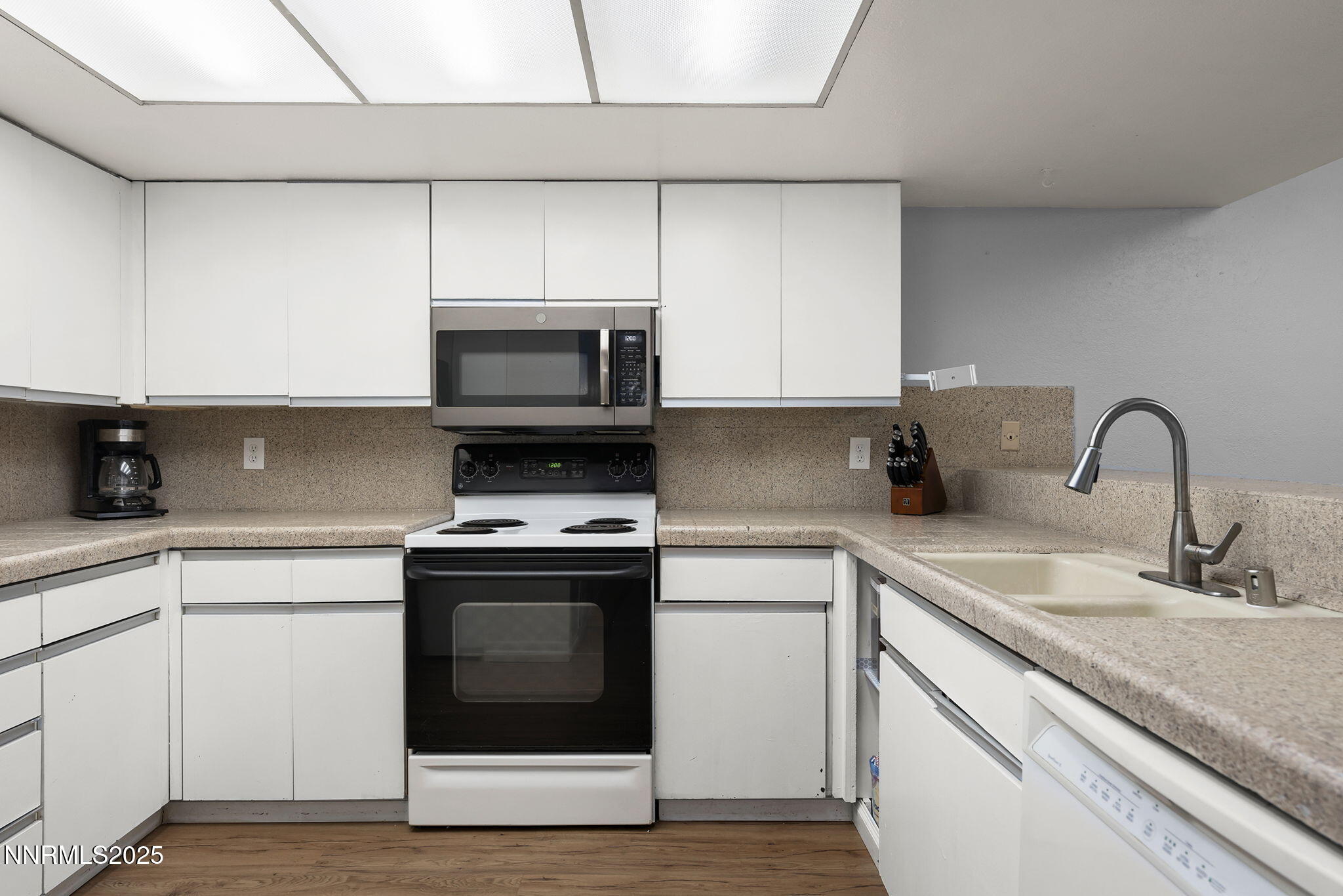 1023 Tyler Way Sparks, NV 89431 - Photo 14 of 21 a kitchen with sink a microwave and stove