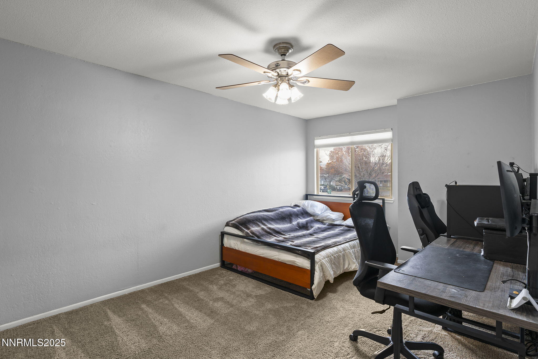 1023 Tyler Way Sparks, NV 89431 - Photo 16 of 21 a bedroom with a bed and a chandelier