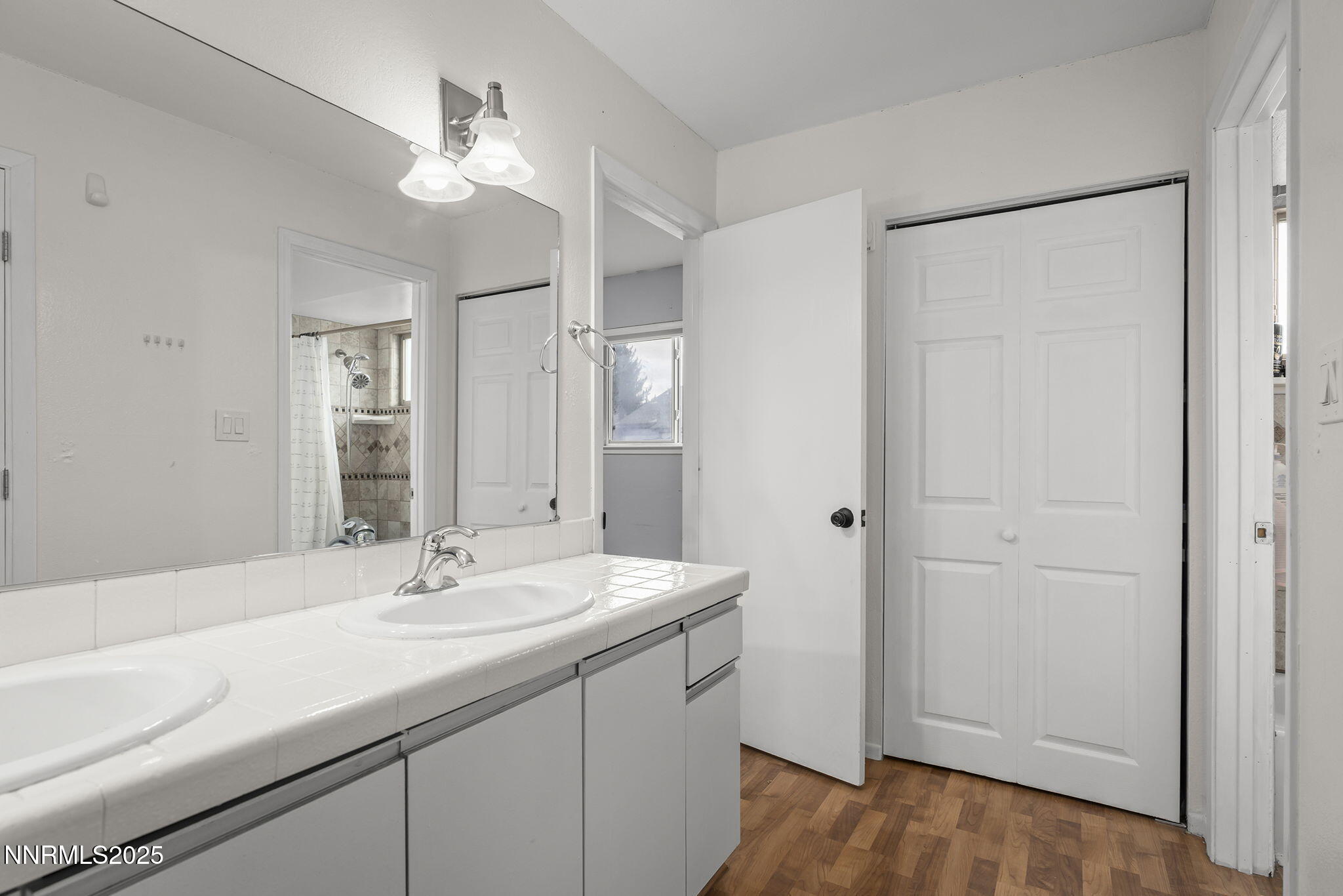 1023 Tyler Way Sparks, NV 89431 - Photo 17 of 21 a bathroom with a sink a light fixture a vanity and a mirror