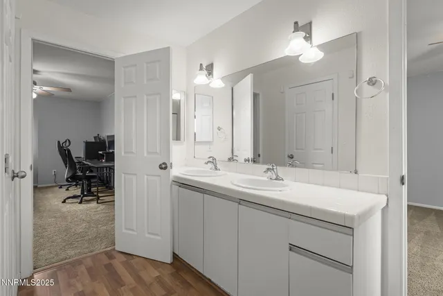 a bathroom with a sink double vanity and a mirror