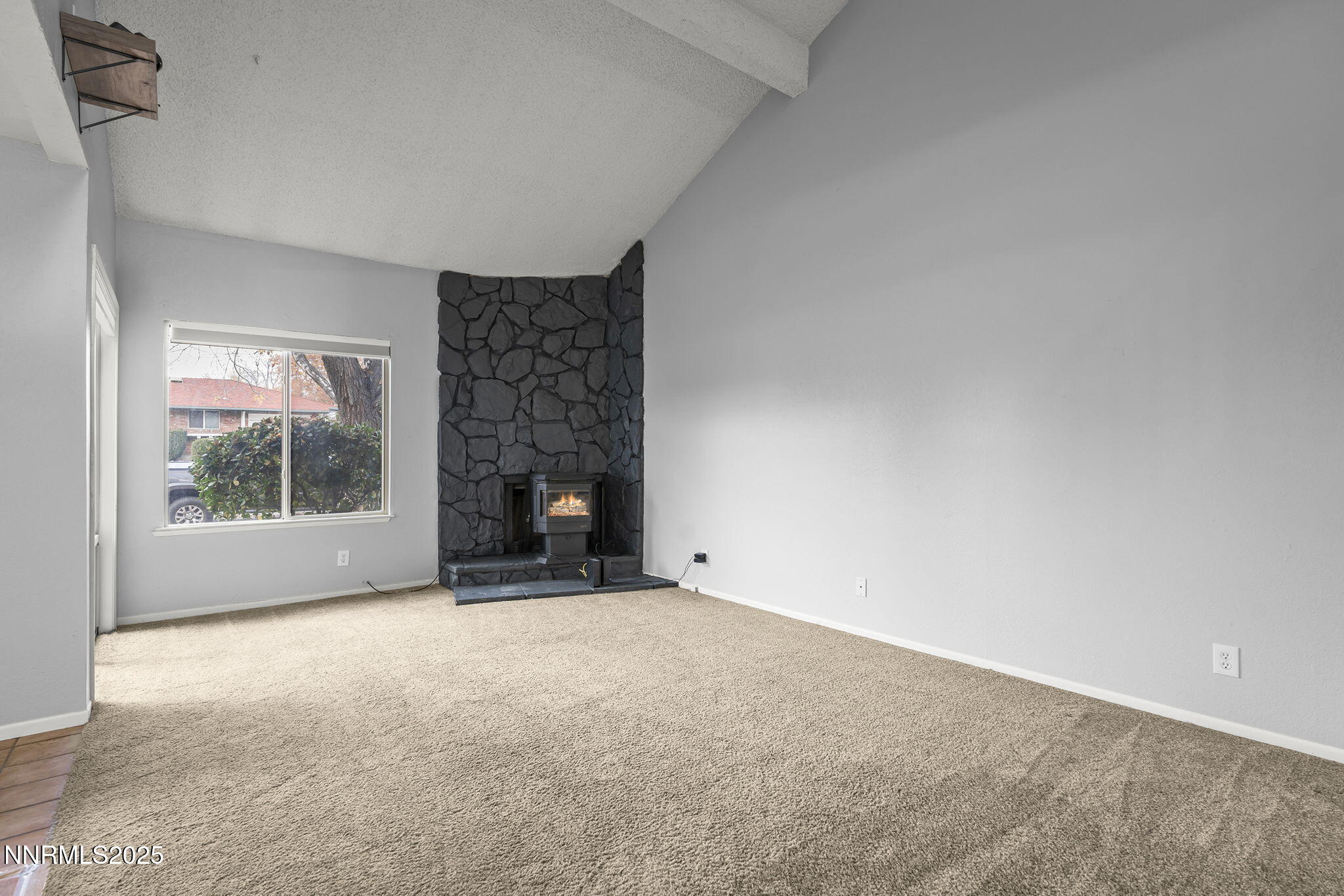 1023 Tyler Way Sparks, NV 89431 - Photo 3 of 21 a view of an empty room with a fireplace and a window
