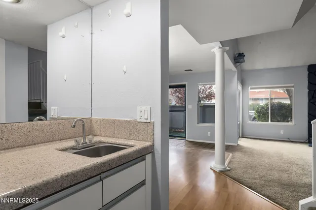 a kitchen with stainless steel appliances granite countertop a sink and a refrigerator
