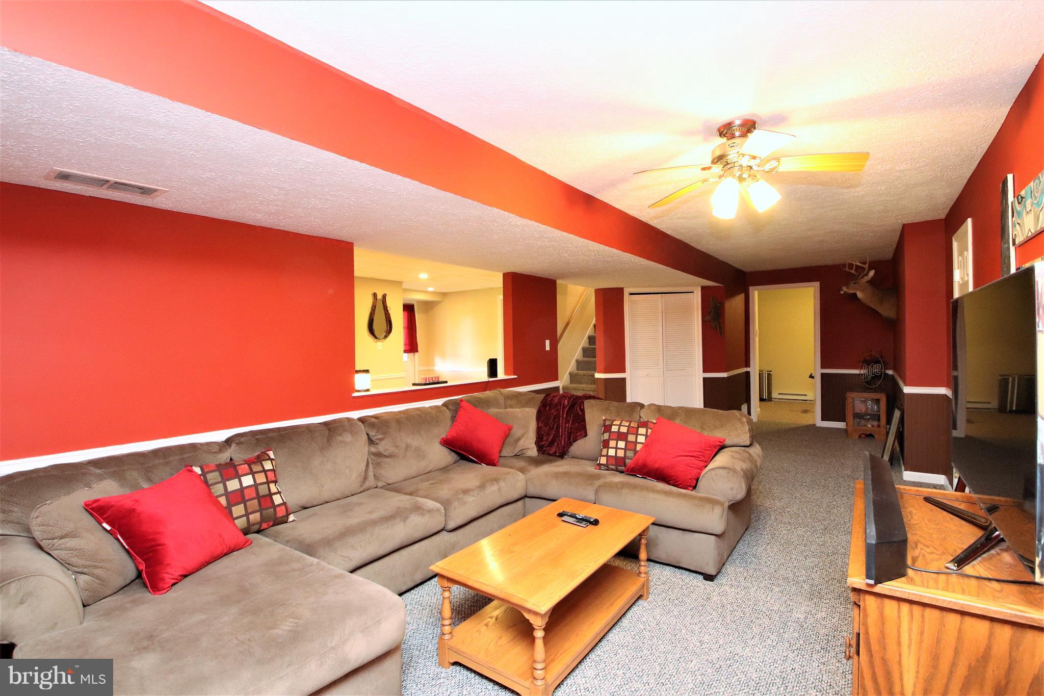 12602 Knepper Road Clear Spring, MD 21722 - Photo 22 of 35 a living room with furniture and a flat screen tv