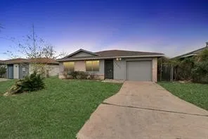 a front view of a house with a garden and yard