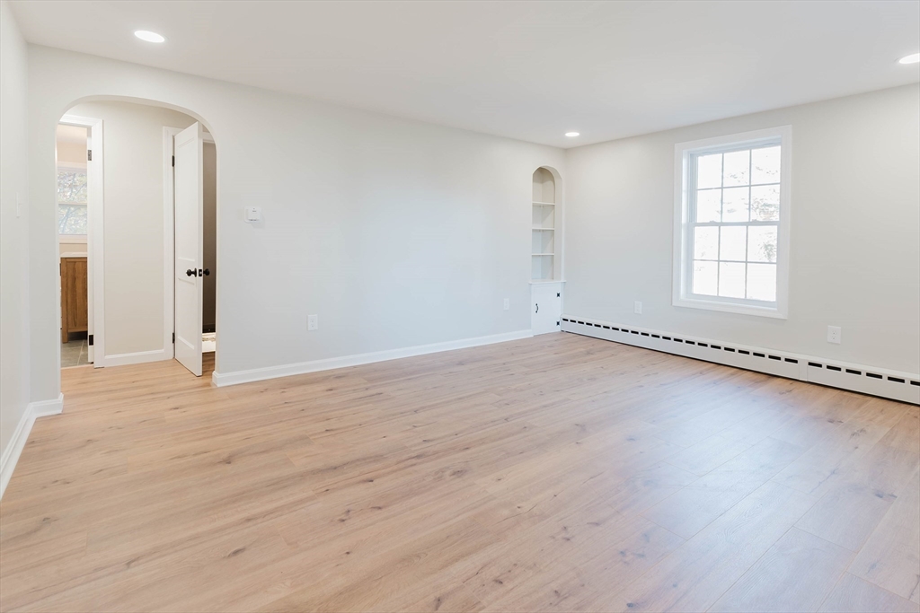 28 Thompson Road Webster, MA 01570 - Photo 2 of 30 an empty room with wooden floor and windows