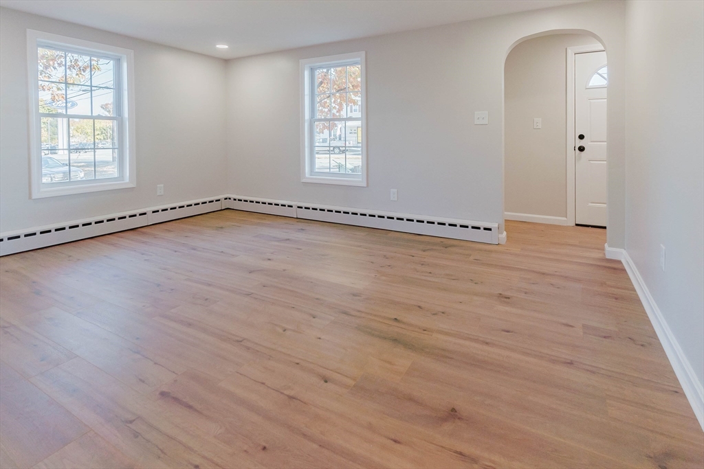28 Thompson Road Webster, MA 01570 - Photo 3 of 30 an empty room with wooden floor and windows