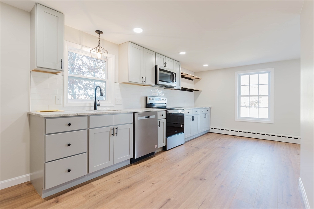 28 Thompson Road Webster, MA 01570 - Photo 4 of 30 a kitchen with granite countertop a sink stainless steel appliances and cabinets