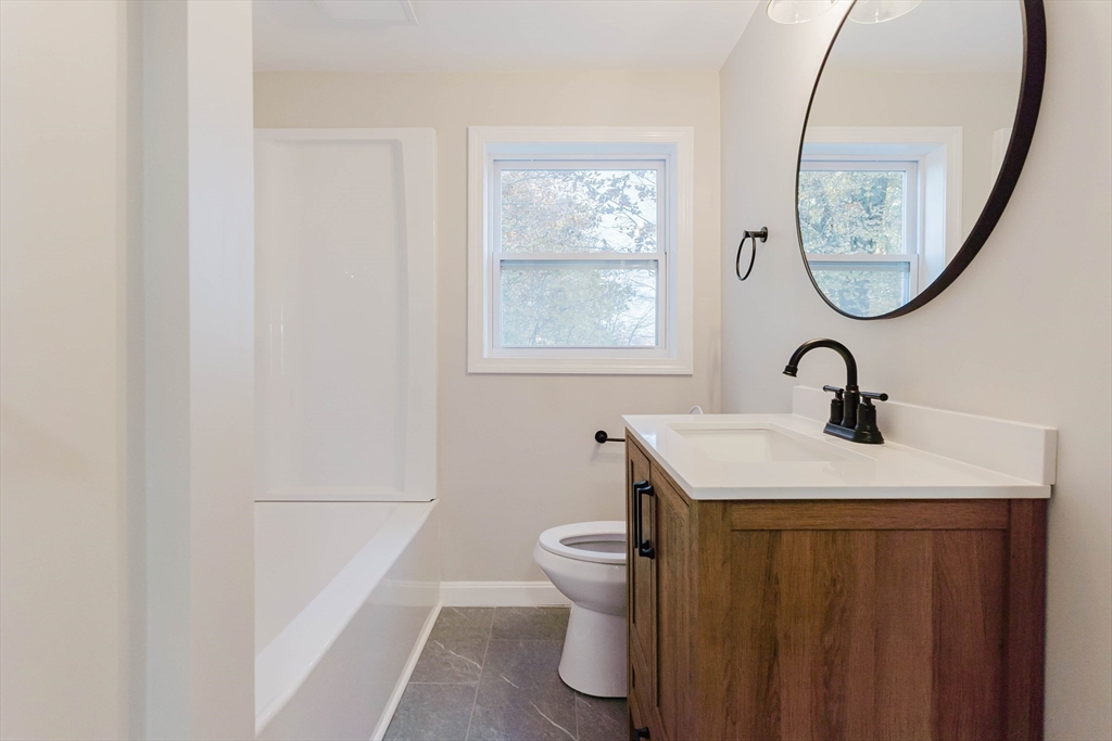 28 Thompson Road Webster, MA 01570 - Photo 9 of 30 a bathroom with a sink a toilet and a mirror