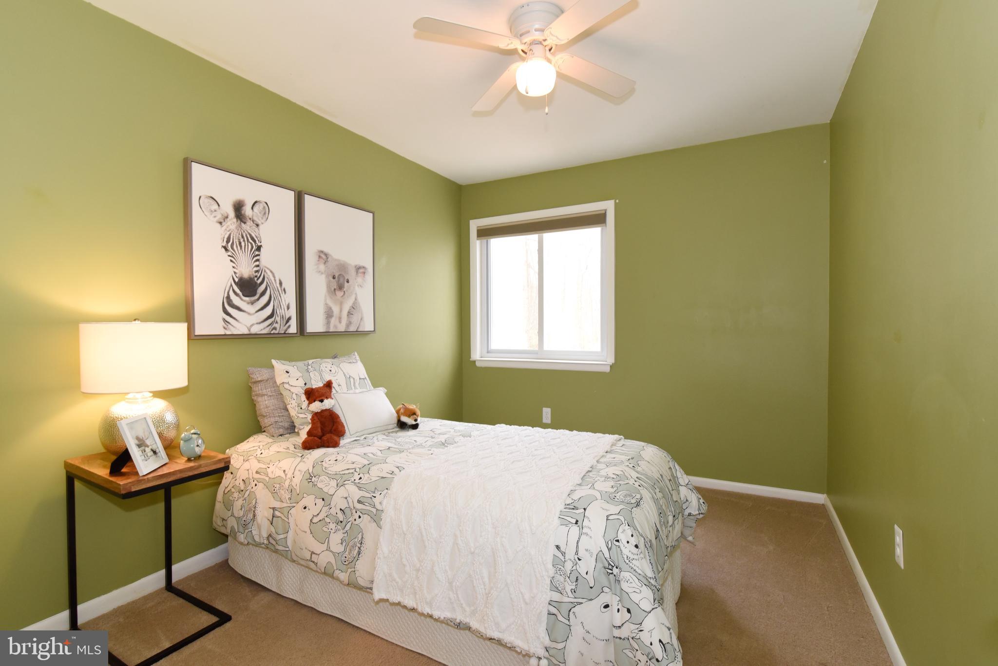 2334 Generation Drive Reston, VA 20191 - Photo 36 of 55 a bedroom with a bed and a chandelier