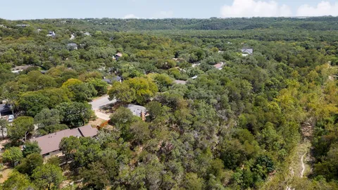 a view of a city with green field