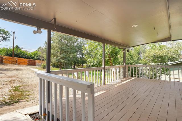 1306 Alexander Road Colorado Springs, CO 80909 - Photo 21 of 26 Lovely covered deck