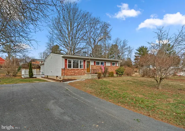 a view of a house with a yard and garage