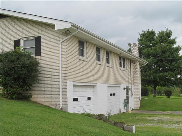 940 Steele Road Charlotte, TN 37036 - Photo 3 of 16 back view of home two car garage in basement
