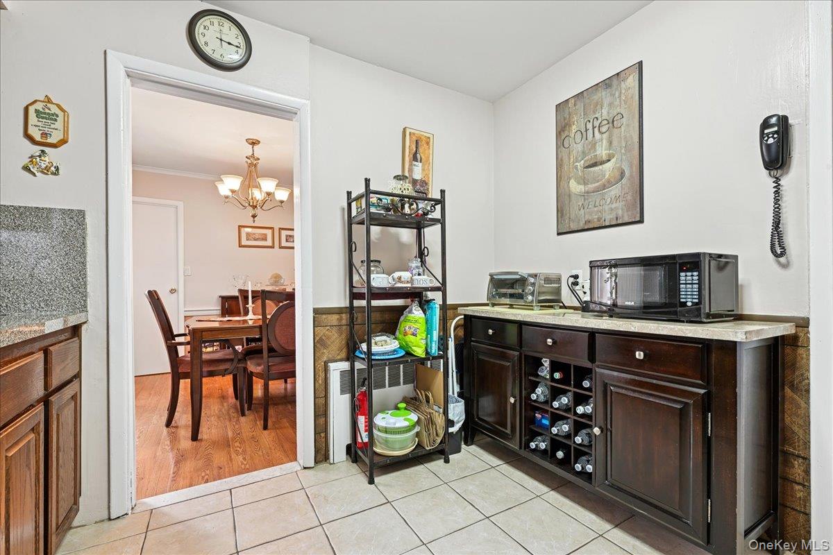 4 East Carpenter Street Valley Stream, NY 11580 - Photo 11 of 34 a kitchen with stainless steel appliances granite countertop a stove and cabinets