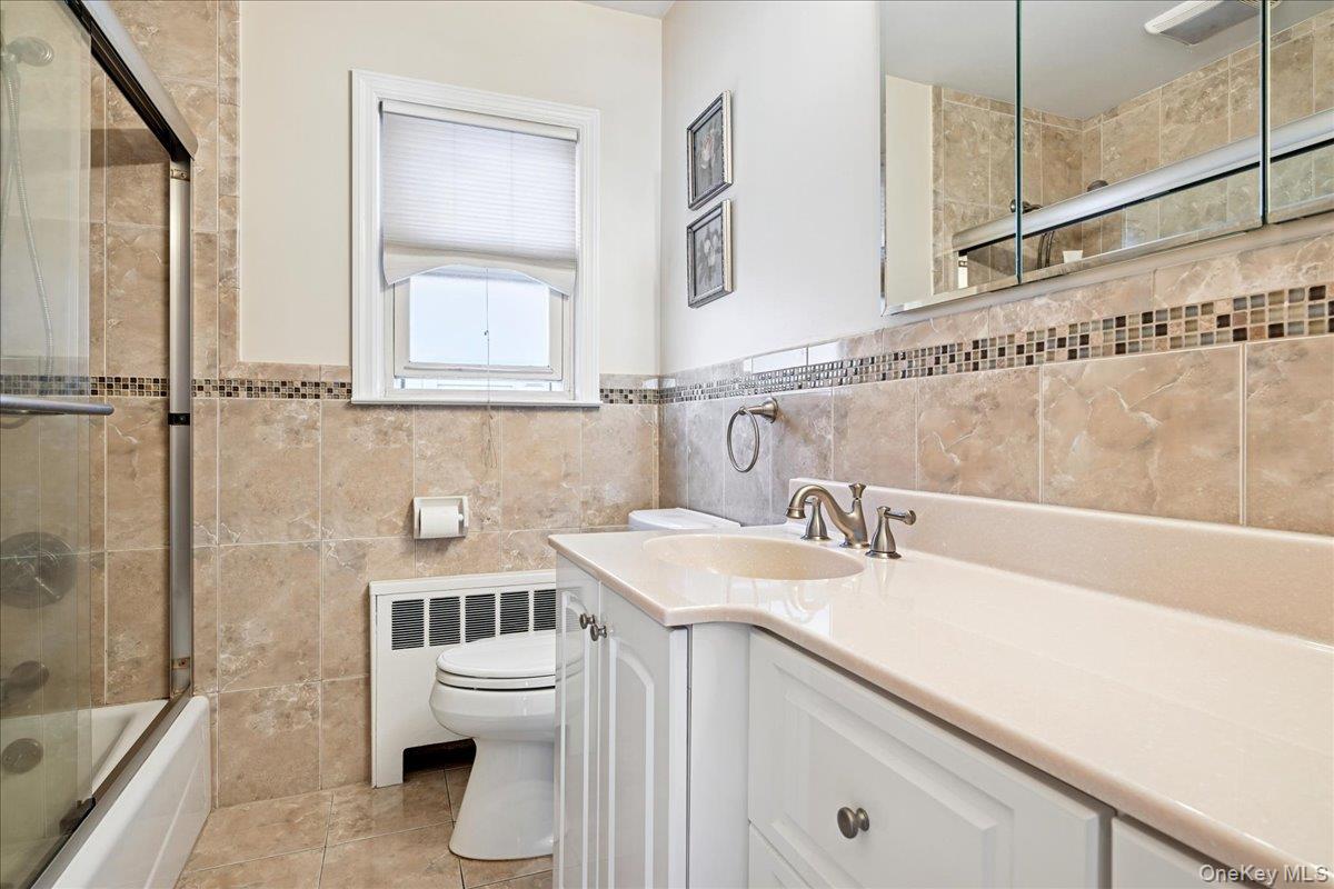 4 East Carpenter Street Valley Stream, NY 11580 - Photo 17 of 34 a bathroom with a sink a toilet and shower