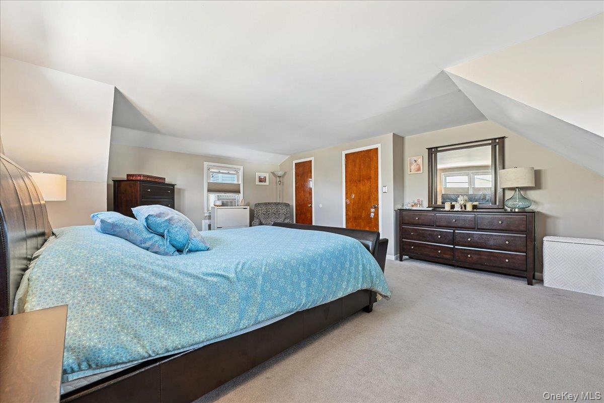 4 East Carpenter Street Valley Stream, NY 11580 - Photo 24 of 34 a bedroom with a bed and dresser with window
