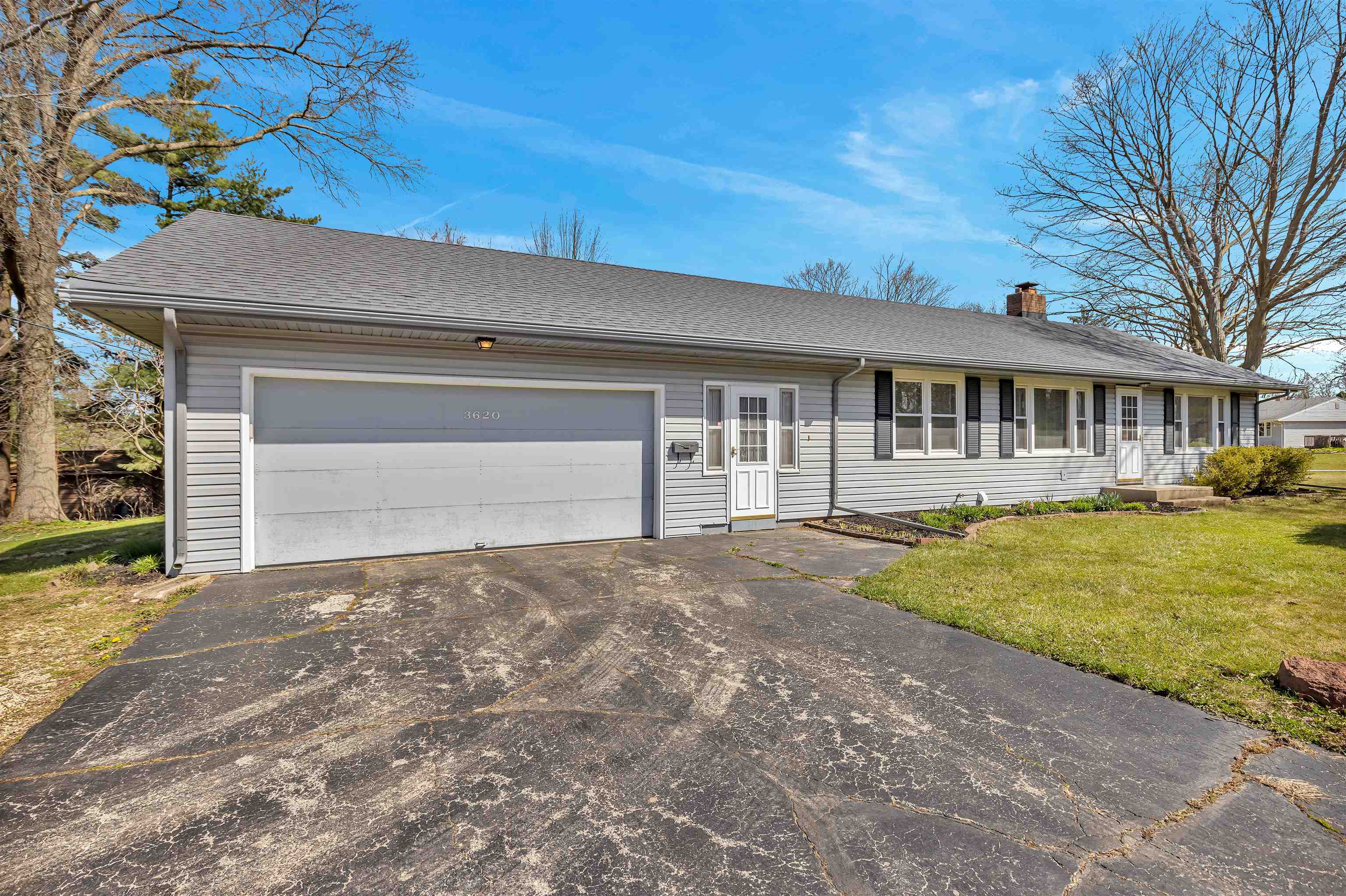 3620 Highcrest Road Rockford, IL 61107 - Photo 1 of 18 a front view of a house with a yard and garage