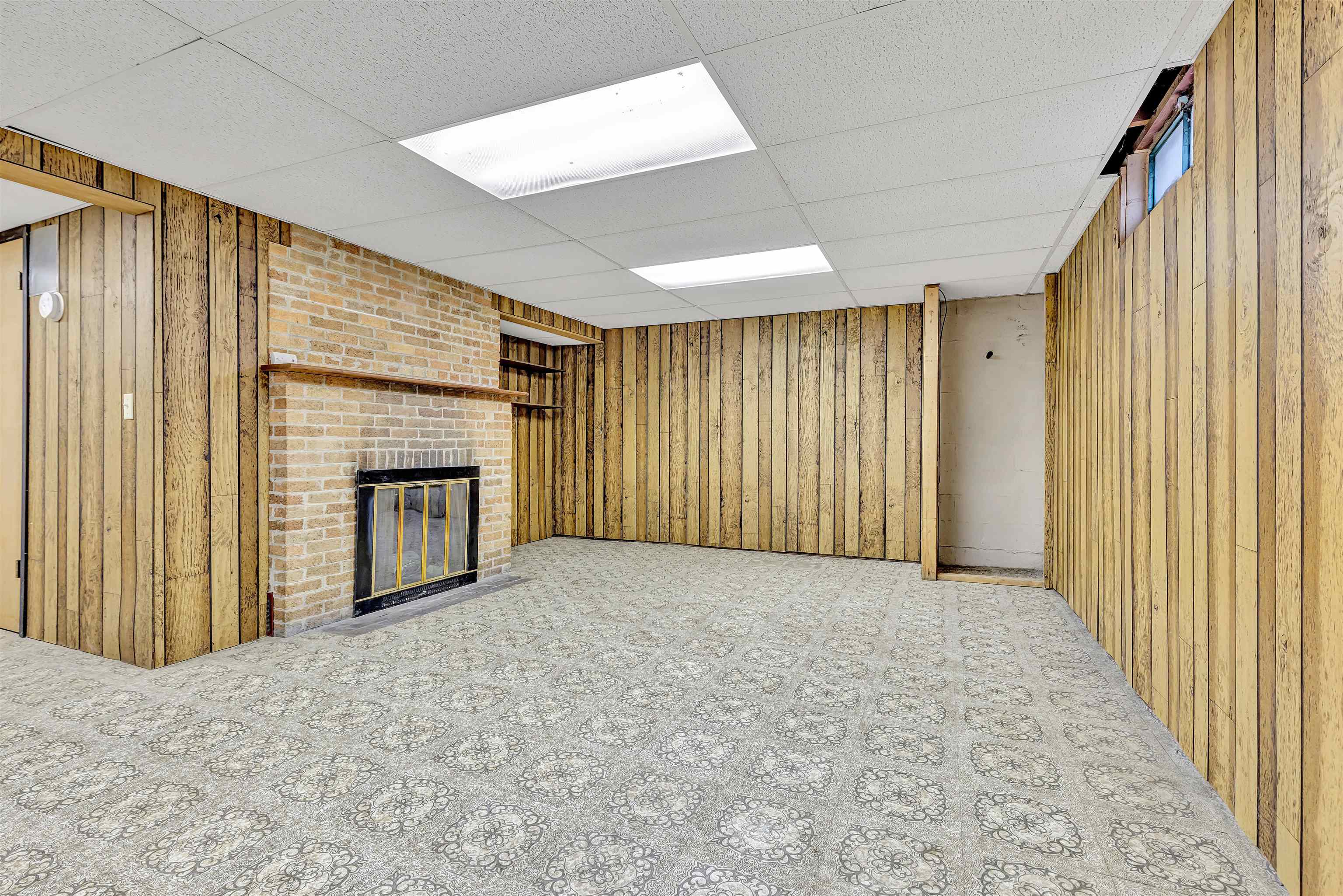 3620 Highcrest Road Rockford, IL 61107 - Photo 14 of 18 en empty room with windows and fireplace