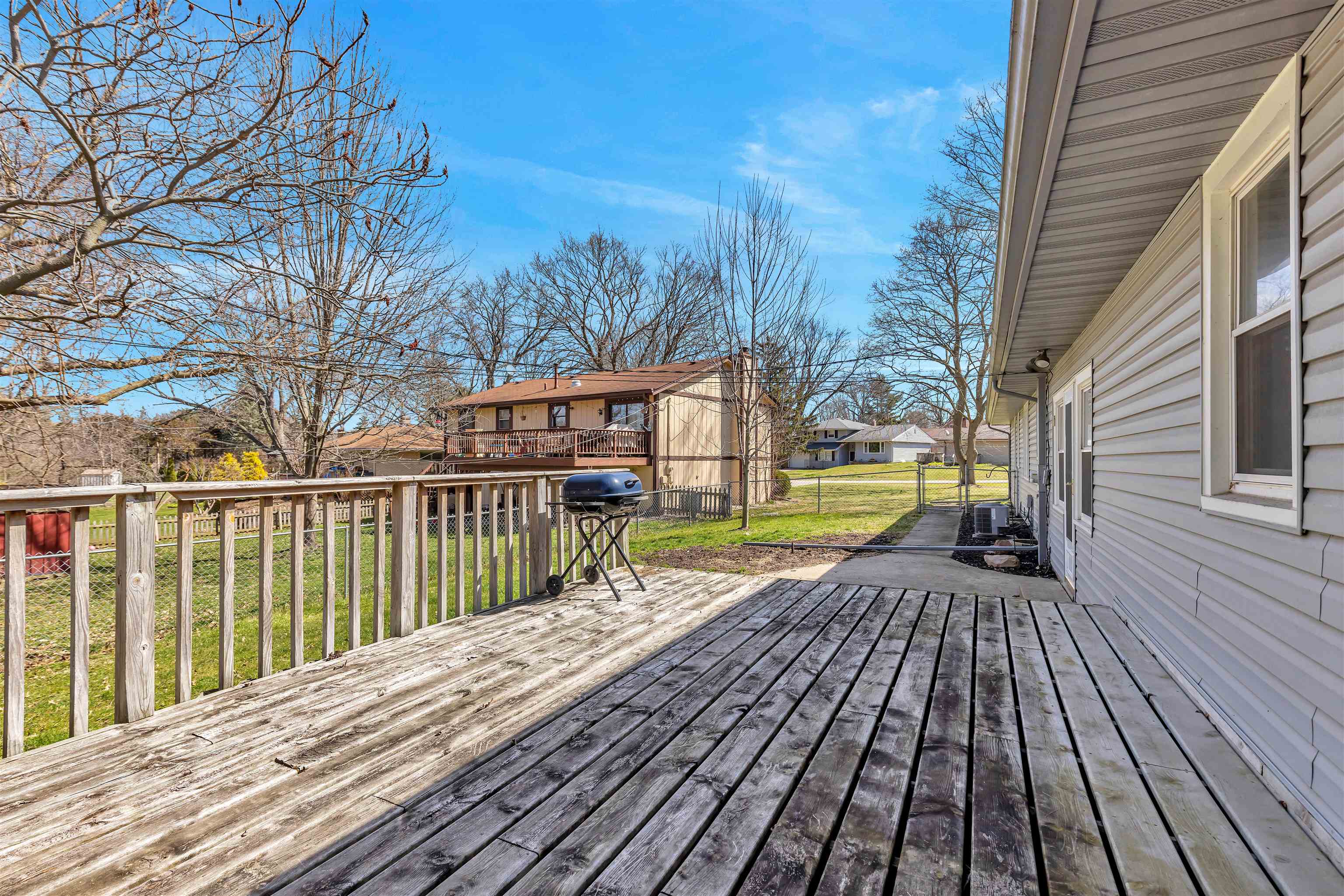3620 Highcrest Road Rockford, IL 61107 - Photo 17 of 18 a view of a wooden deck with a yard