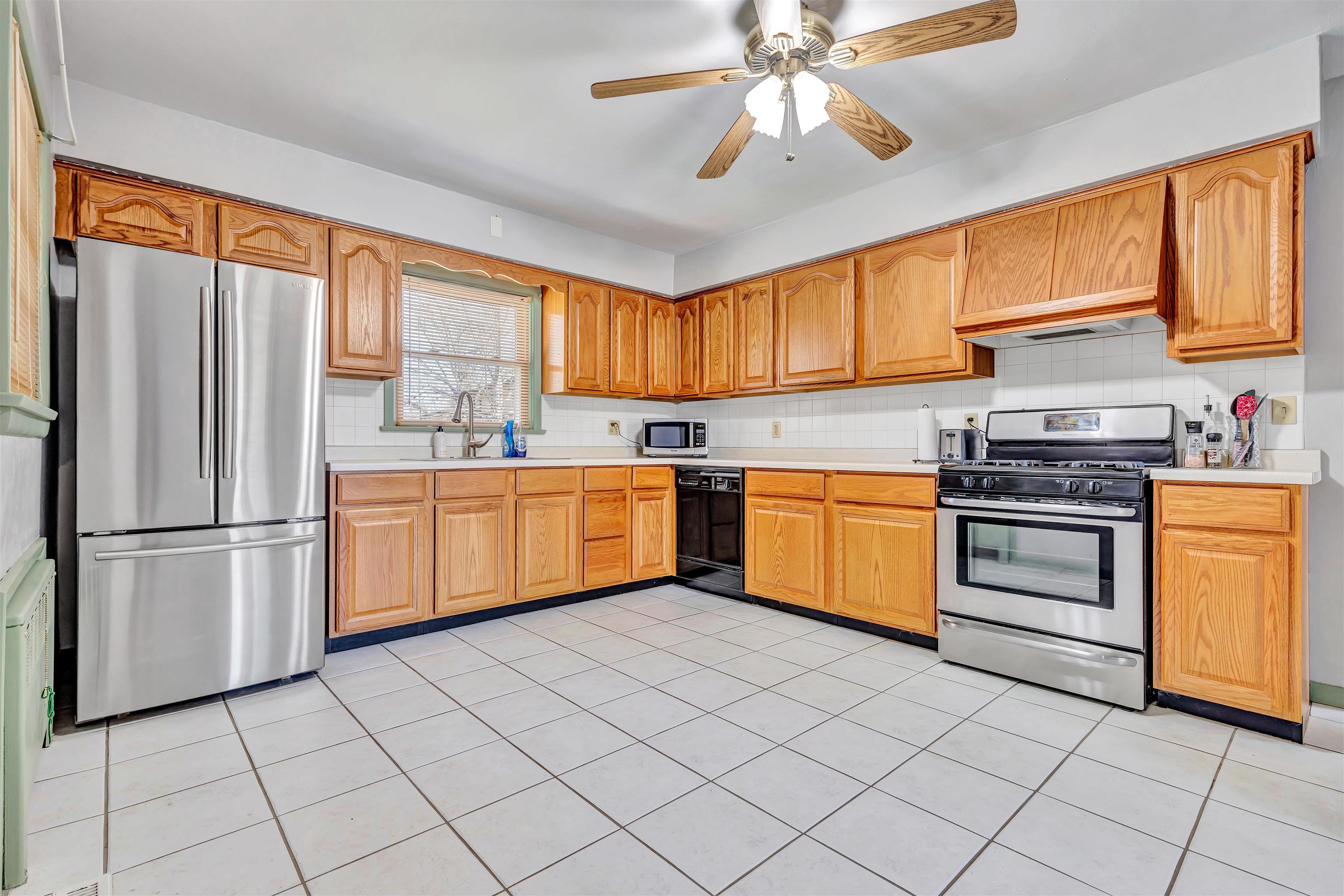 3620 Highcrest Road Rockford, IL 61107 - Photo 7 of 18 a kitchen with a stove a sink dishwasher and a refrigerator